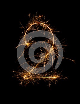 Digit 2 or two made of bengal fire, sparkler fireworks candle isolated on a black background