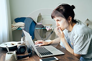 Digital addiction, woman in panic reads articles about coronavirus on Internet