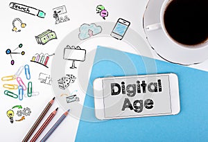 Digital Age. Mobile phone and coffee cup on a white office desk