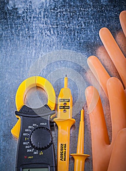 Digital ammeter electrical tester electricians rubber gloves on