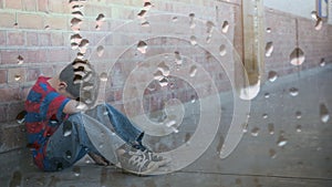 Digital animation of upset boy sitting against the wall with head down