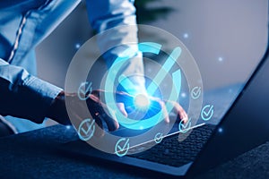 Digital approval concept with glowing checkmark icon on laptop screen, representing task completion, project validation, and goal