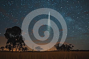 Digital artwork of  bright comet in the night sky over an open field with trees
