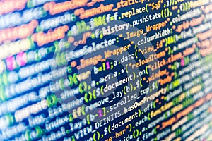 Digital binary data on computer screen. Coding script text on screen.