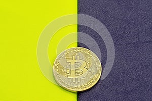 Digital bitcoin on a acid on a purple background.