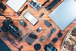 Digital camera, charger, camera, lens, video camera, USB, personal laptop, mockup phone, book, pen, glasses, remote control, and