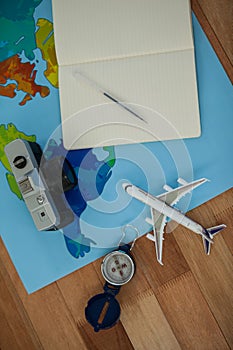 Digital camera, dairy, pen, map, compass and airplane model