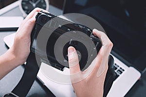 Digital camera on hand Photographer work desk