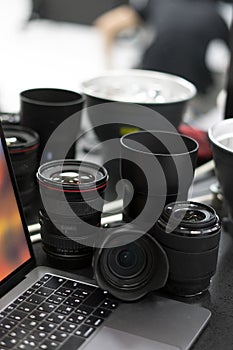 Digital camera, lens and laptop. concept of photographer work station