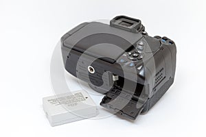 Digital camera with open battery compartment.