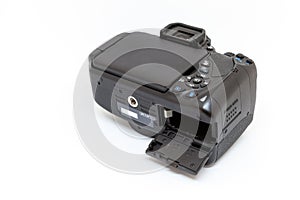 Digital camera with open battery compartment.