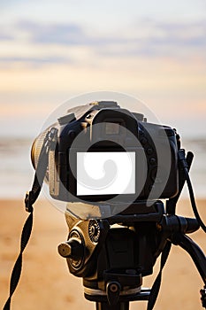 Digital camera on the tripod white screen