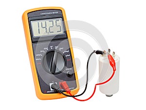 Digital capacitance meter testing one white capacitor