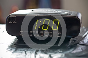 Digital clock closeup displaying 1:00 o`clock.
