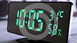 Digital Clock Showing Time on Green Display 10:05 AM, Temperature, Air Humidity