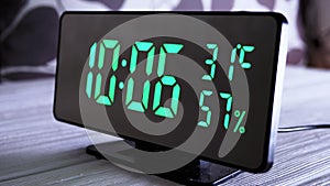 Digital Clock Showing Time on Green Display 10:06 AM, Temperature, Air Humidity