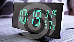 Digital Clock Showing Time on Green Display 10:19 AM, Temperature, Air Humidity