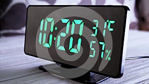 Digital Clock Showing Time on Green Display 10:20 AM, Temperature, Air Humidity