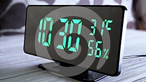 Digital Clock Showing Time on Green Display 10:30 AM, Temperature, Air Humidity