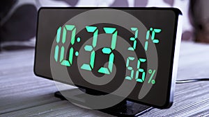 Digital Clock Showing Time on Green Display 10:33 AM, Temperature, Air Humidity