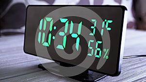 Digital Clock Showing Time on Green Display 10:34 AM, Temperature, Air Humidity