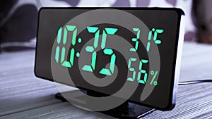 Digital Clock Showing Time on Green Display 10:35 AM, Temperature, Air Humidity