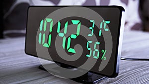 Digital Clock Showing Time on Green Display 10:42 AM, Temperature, Air Humidity