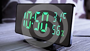 Digital Clock Showing Time on Green Display 10:50 AM, Temperature, Air Humidity