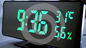 Digital Clock Showing Time on Green Display 9:36 AM, Temperature, Air Humidity