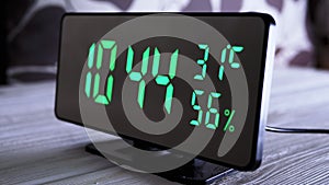 Digital Clock Showing Time on Green Display 9:44 AM, Temperature, Air Humidity