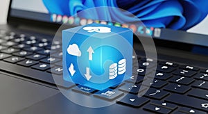 Digital cloud computing cube symbolizing data storage and transfer on a laptop keyboard