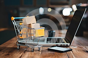 Digital commerce integration shopping cart and boxes on laptop