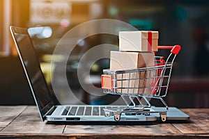 Digital commerce integration shopping cart and boxes on laptop