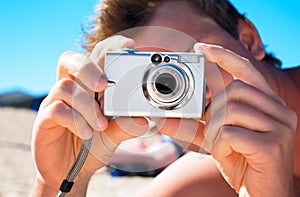Digital compact photo camera in hands