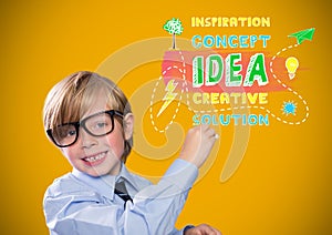 Boy writing in front of yellow blank background with concept idea graphics