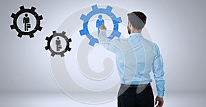 Businessman interacting and choosing a person from group of people icons with cog gear settings symb photo