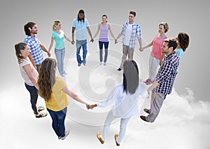 Circle of people holding hands together on clouds