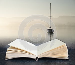 Digital composite concept image of open book wth Stunning unplugged fine art landscape image of sailing yacht sitting still in