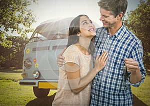 Couple Holding key in front of camper van