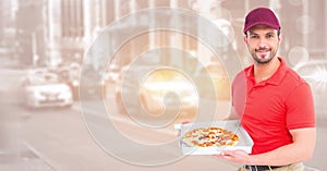 Delivery man with pizza against blurry street with flare and bokeh