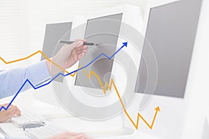 Hand using computer with graph overlays