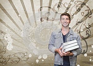 Happy young student man holding books against brown and white splattered background