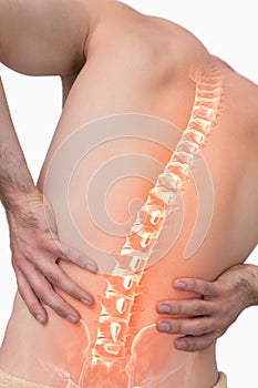 Digital composite of highlighted spine of man with back pain