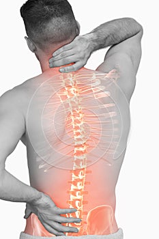 Digital composite of highlighted spine of man with back pain