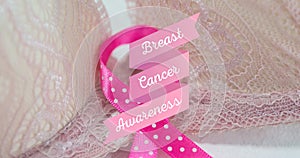 Digital composite image of breast cancer awareness on beige bra