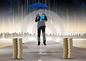 Digital composite image of businessman holding blue umbrella balancing on rope amidst stack of coins