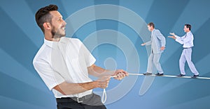 Digital composite image of businessmen walking on rope held by manager