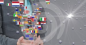 Digital composite image of businesswoman standing with flags and connecting dots