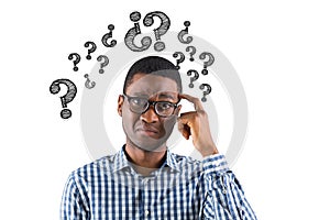 Digital composite image of confused businessman with question marks photo