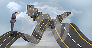 Digital composite image of confused businessman on wavy road in sky